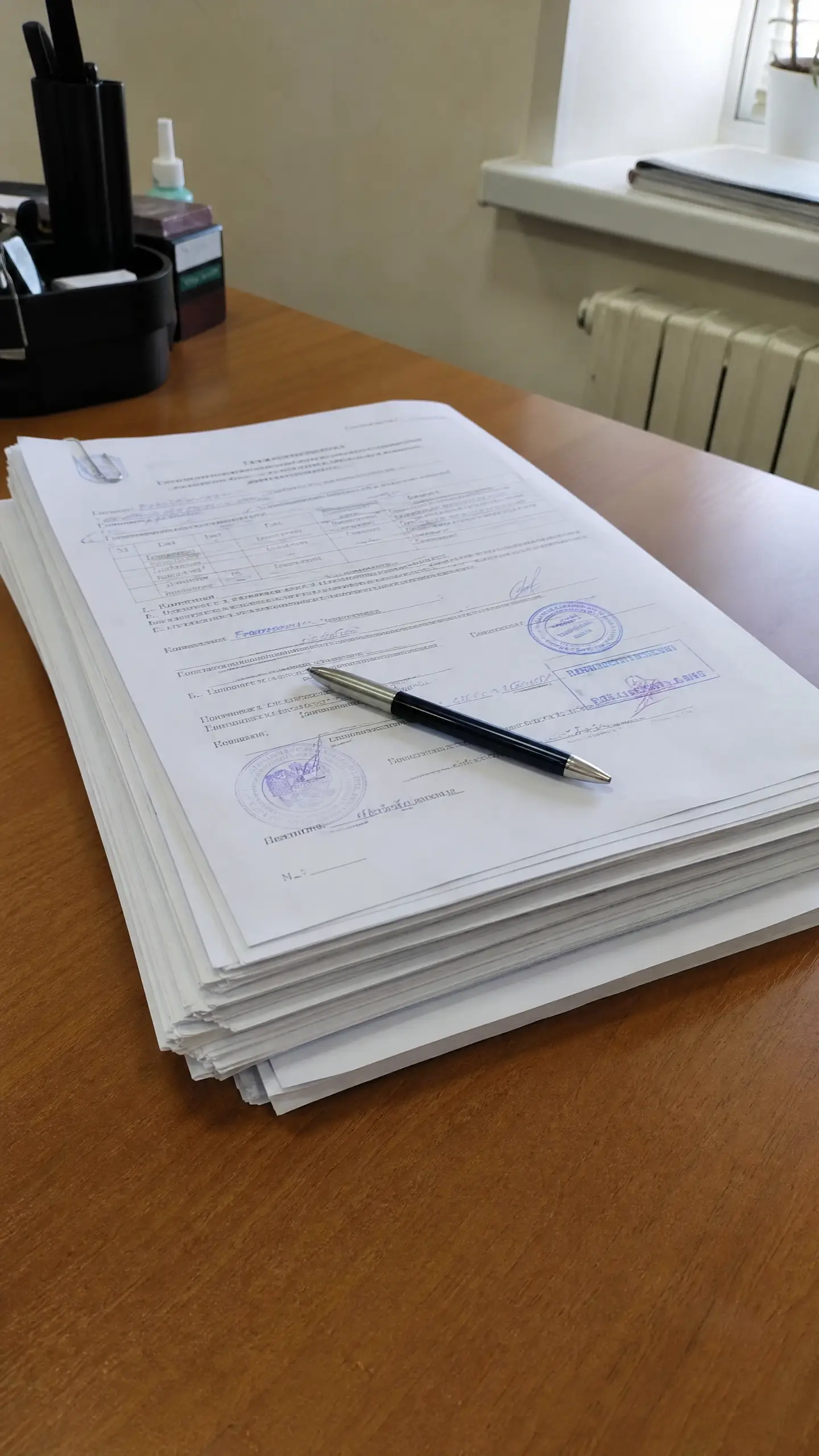 A stack of stamped documents on a desk